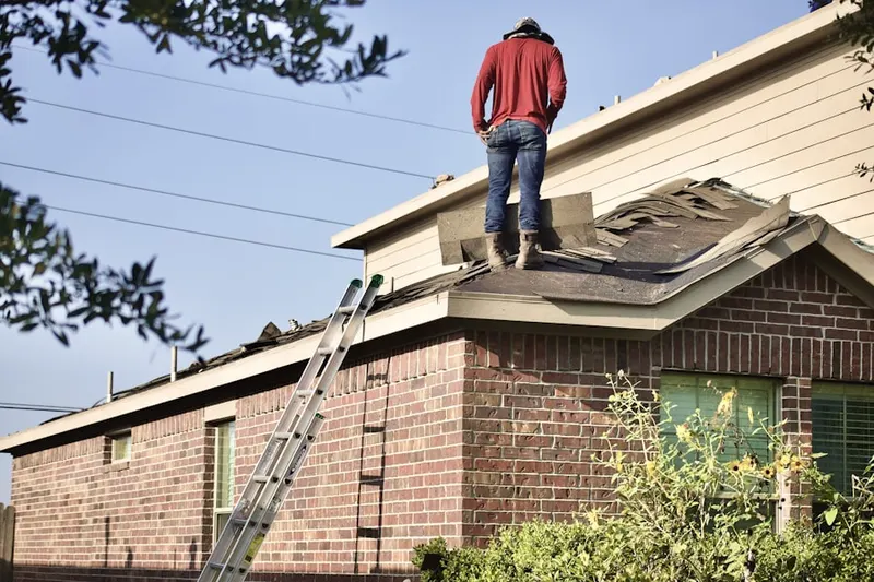 Professional roofer working on a residential roof in Loop